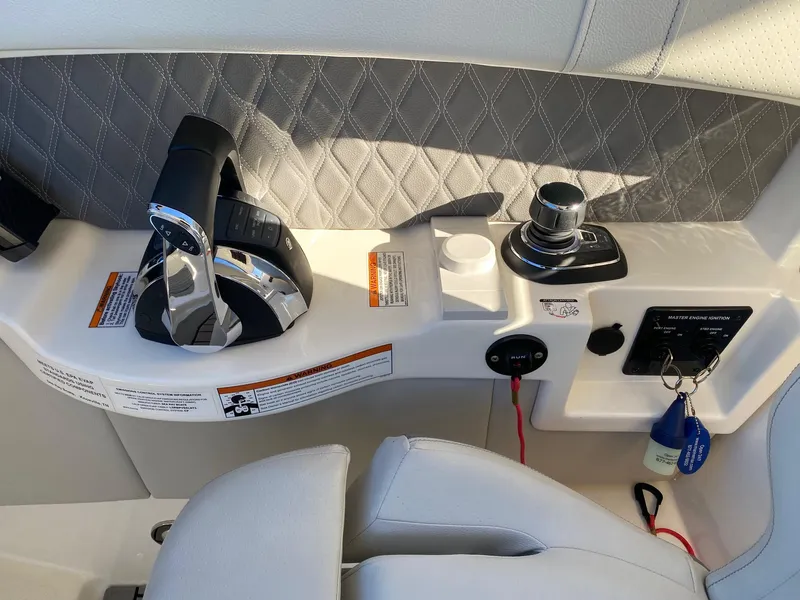 Slide: The Image of 2020 Sea Ray SLX 350 helm controls with modern steering and throttle system. - 9
