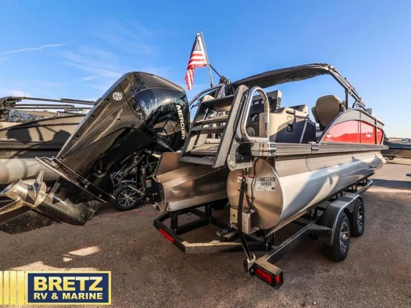 Slide: The Image of 2025 Cabrio Ultra-Lounge 22UC pontoon boat on trailer, featuring Mercury outboard motor. - 6