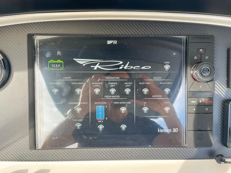 Slide: The Image of Control panel of 2025 Ribco Venom 30 boat with touchscreen interface. - 16