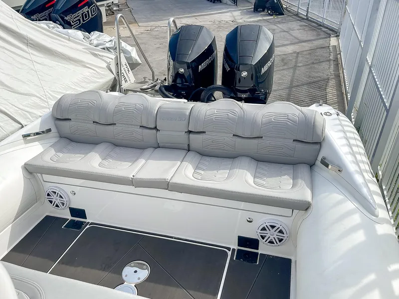 Slide: The Image of 2025 Ribco Venom 30 boat with cushioned seating and dual outboard motors. - 19