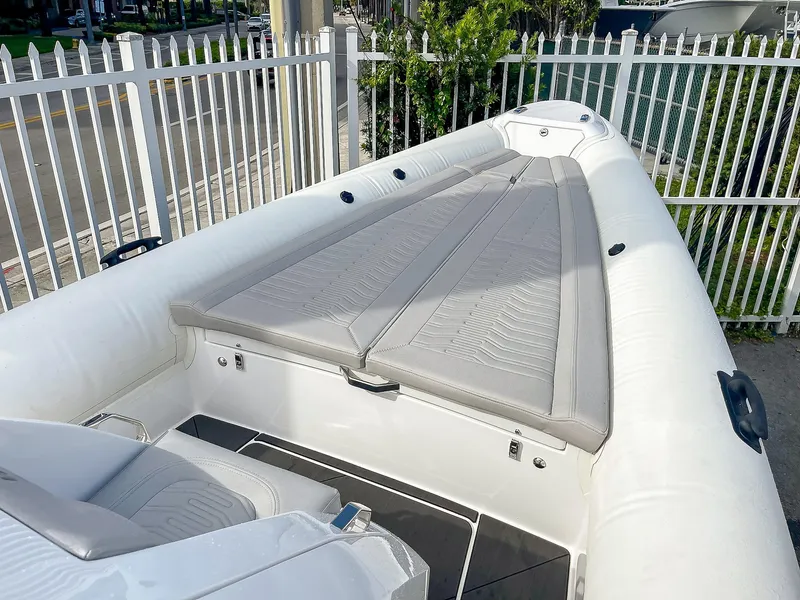 Slide: The Image of 2025 Ribco Venom 30 boat with sleek white design and spacious seating area. - 20