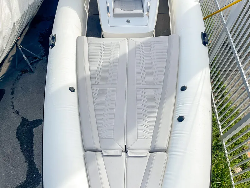 Slide: The Image of Ribco Venom 30 boat, 2025 model, featuring sleek white seating and modern design. - 24