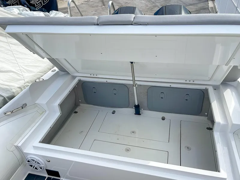 Slide: The Image of Open storage compartment on a 2025 Ribco Venom 30 boat. - 31
