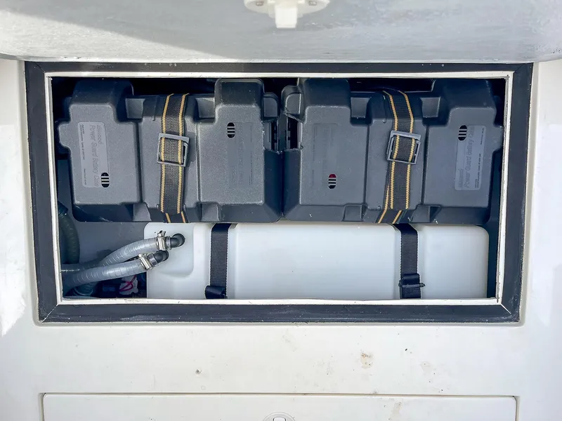 Slide: The Image of Battery compartment of 2025 Ribco Venom 30 boat, featuring secure black battery boxes. - 33