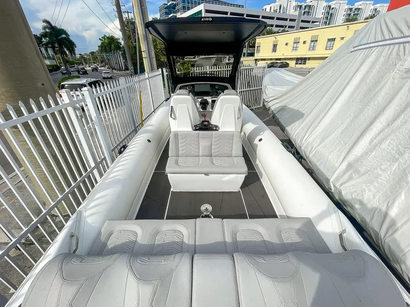 Slide: The Image of 2025 Ribco Venom 30 boat interior with white seating and modern design. - 7