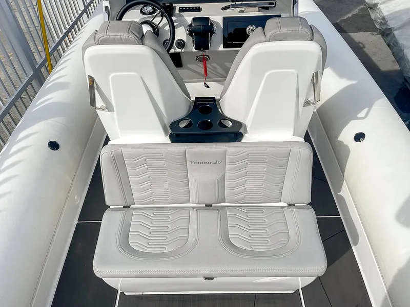 Slide: The Image of 2025 Ribco Venom 30 boat interior with dual seats and steering console. - 9