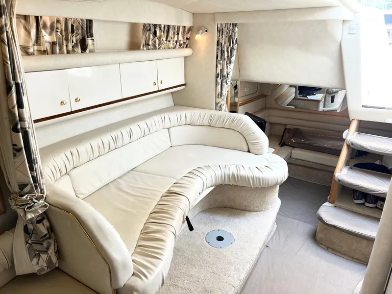 Slide: The Image of Interior of 1997 Sea Ray 330 Sundancer Cruiser with plush seating and elegant design. - 16