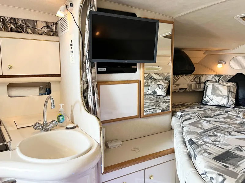 Slide: The Image of Interior of 1997 Sea Ray 330 Sundancer Cruiser with sink, TV, and bed. - 18