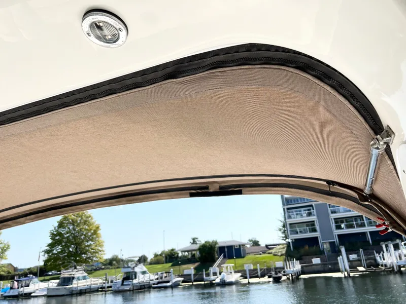 Slide: The Image of 1997 Sea Ray 330 Sundancer Cruiser canopy with marina view in the background. - 20