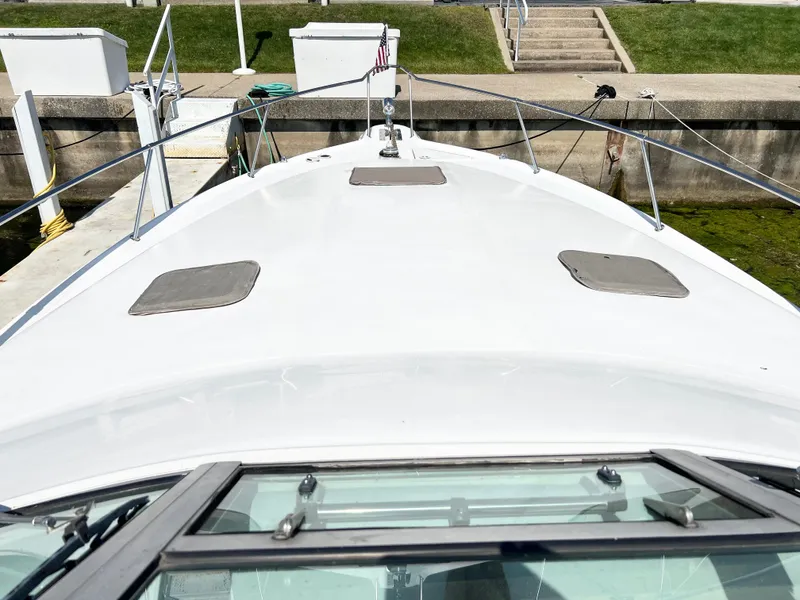 Slide: The Image of 1997 Sea Ray 330 Sundancer Cruiser docked, view from the bow. - 21