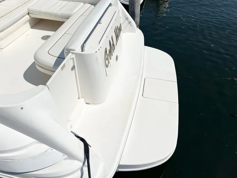Slide: The Image of 1997 Sea Ray 330 Sundancer Cruiser's rear deck by the water. - 5