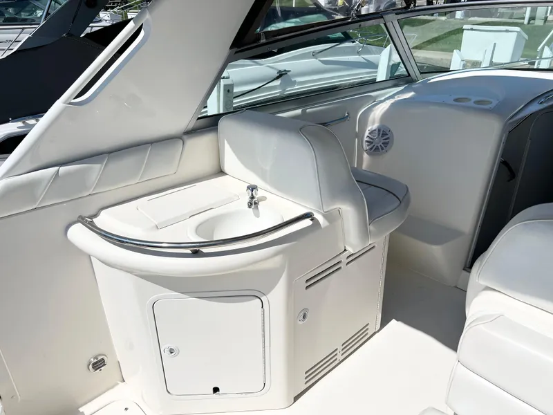 Slide: The Image of 1997 Sea Ray 330 Sundancer Cruiser interior with sink and seating area. - 6