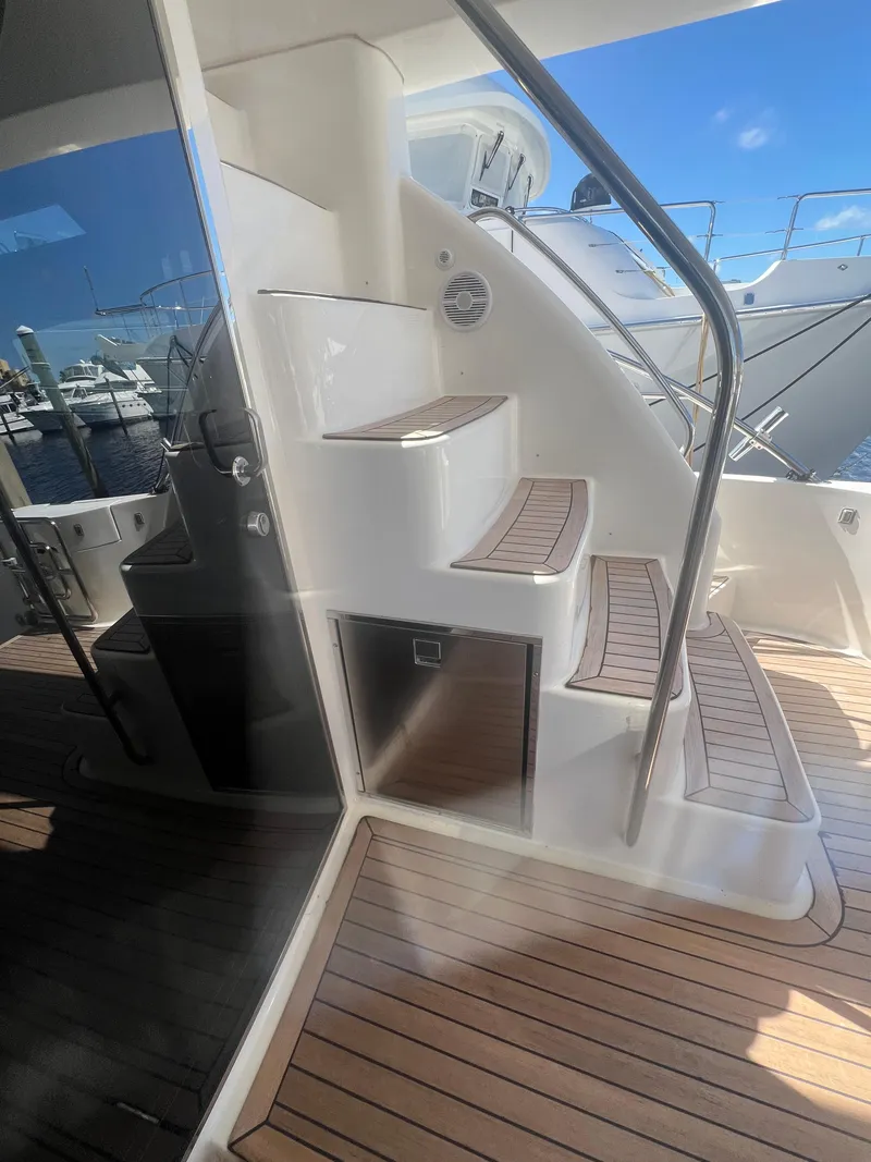 Slide: The Image of 2005 Neptunus 62 Flybridge yacht with teak steps and stainless steel railing. - 12