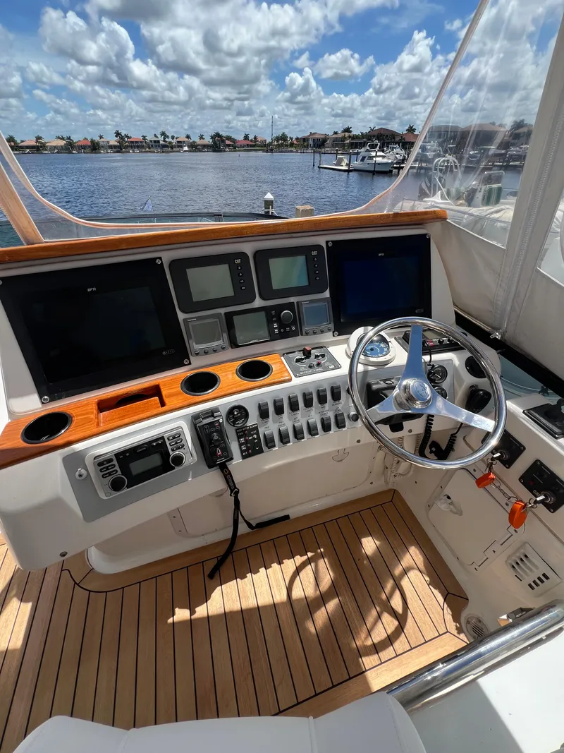 Slide: The Image of Helm of 2005 Neptunus 62 Flybridge yacht with navigation equipment and steering wheel. - 15