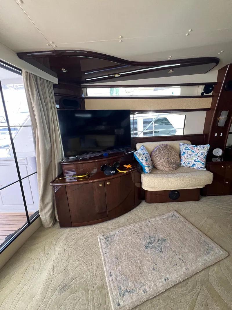 Slide: The Image of Luxurious interior of 2005 Neptunus 62 Flybridge yacht with TV and seating area. - 21