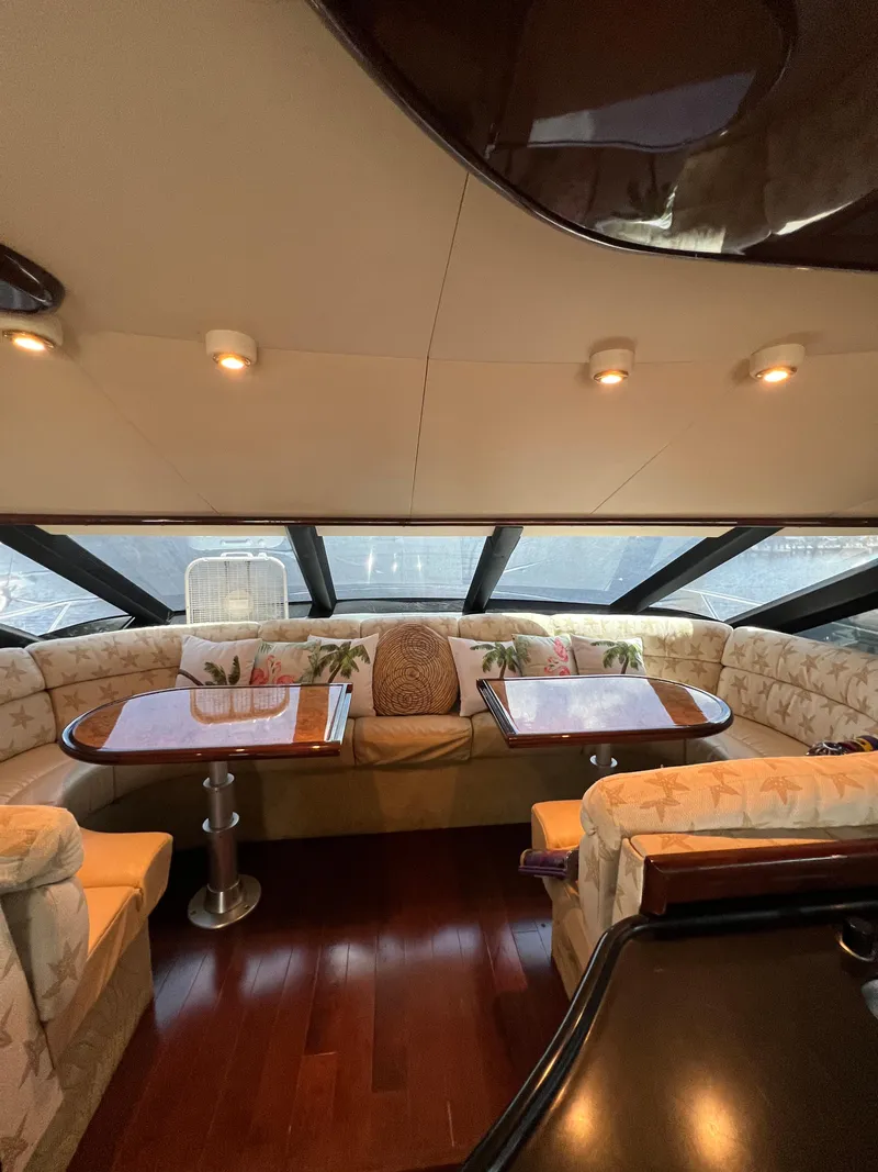 Slide: The Image of Luxurious 2005 Neptunus 62 Flybridge yacht interior with elegant seating and wooden flooring. - 30