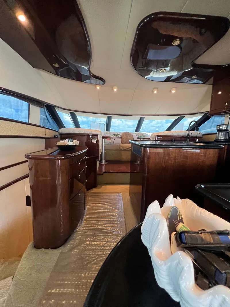 Slide: The Image of Luxurious interior of 2005 Neptunus 62 Flybridge yacht with elegant wood finishes. - 31