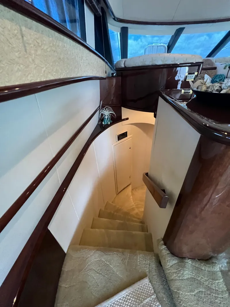 Slide: The Image of Interior staircase of 2005 Neptunus 62 Flybridge yacht with elegant wood finish. - 32