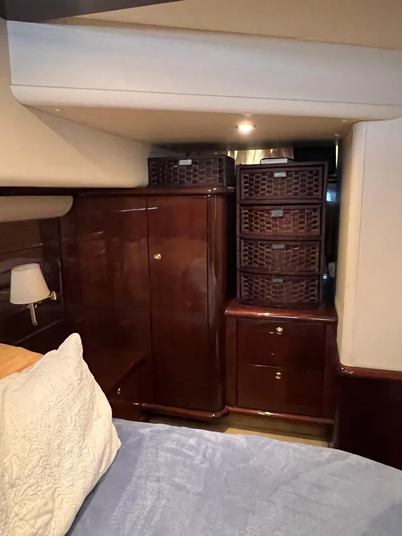 Slide: The Image of Luxurious 2005 Neptunus 62 Flybridge cabin with elegant wood cabinetry and cozy bedding. - 37