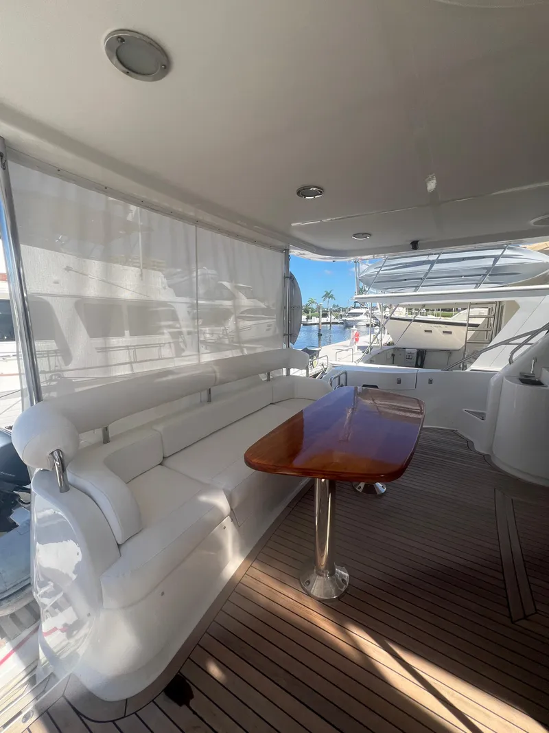 Slide: The Image of Luxurious 2005 Neptunus 62 Flybridge yacht interior with elegant seating and wooden table. - 5