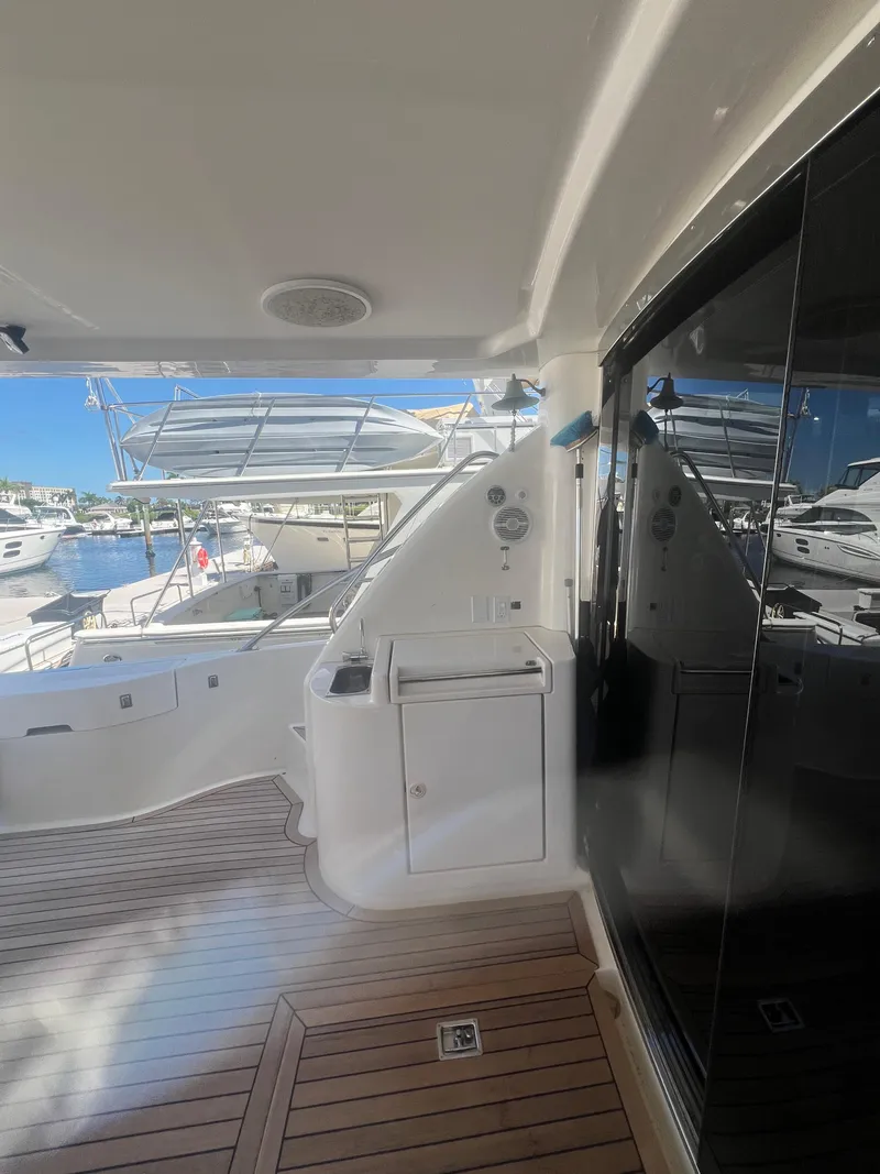 Slide: The Image of 2005 Neptunus 62 Flybridge yacht deck with sleek design and marina view. - 6