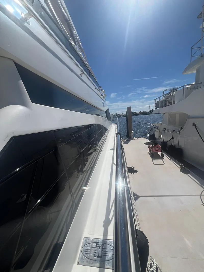 Slide: The Image of 2005 Neptunus 62 Flybridge yacht docked under clear blue sky. - 7