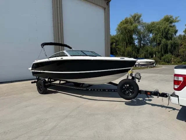 The Image of 2025 Four Winns H1 boat on trailer, parked outdoors near a building. - 0