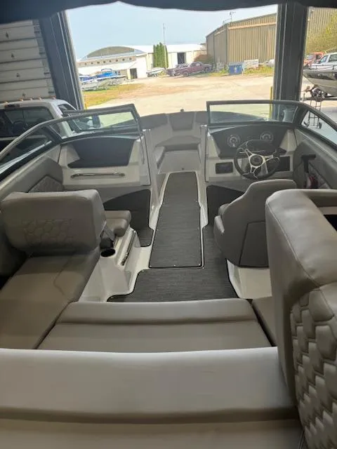 Slide: The Image of 2025 Four Winns H1 boat interior with modern seating and steering wheel. - 9