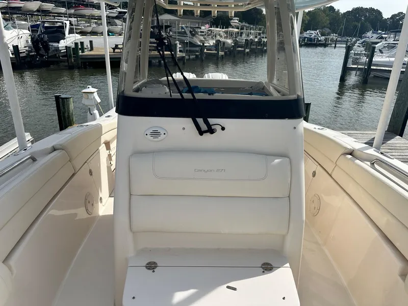 Slide: The Image of 2022 Grady-White Canyon 271 boat docked at marina, showcasing spacious deck and seating. - 14