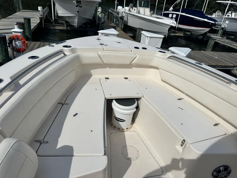 Slide: The Image of 2022 Grady-White Canyon 271 boat interior at dock, featuring spacious seating and storage. - 15