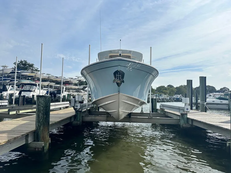 Slide: The Image of 2022 Grady-White Canyon 271 boat docked at marina, front view. - 2