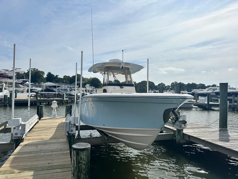 Slide: The Image of 2022 Grady-White Canyon 271 boat docked at marina under clear sky. - 5