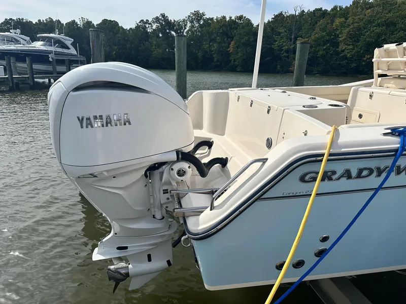 Slide: The Image of 2022 Grady-White Canyon 271 boat with Yamaha outboard motor docked by the water. - 6