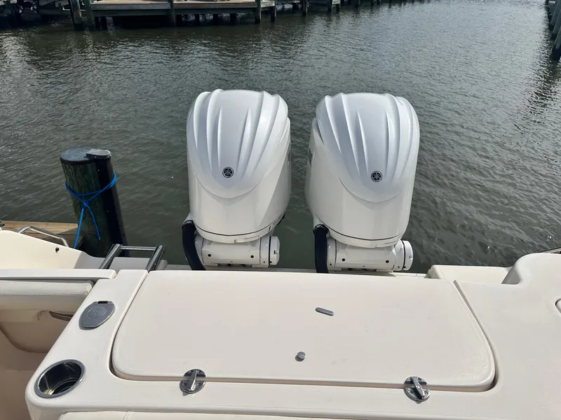 Slide: The Image of 2022 Grady-White Canyon 271 boat with twin outboard engines on water. - 7