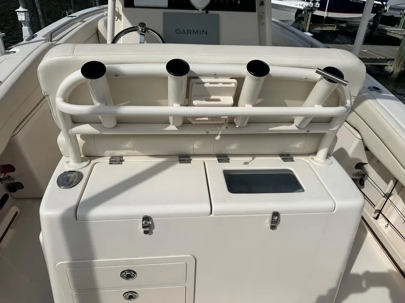 Slide: The Image of 2022 Grady-White Canyon 271 boat interior with rod holders and storage compartments. - 9