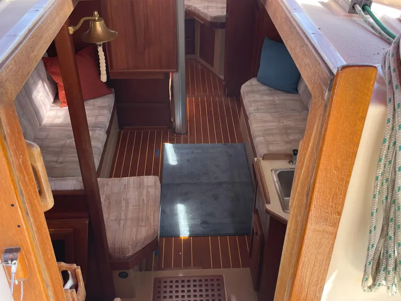 Slide: The Image of Interior of 1992 Island Packet 32 sailboat with wood finish and cozy seating. - 14
