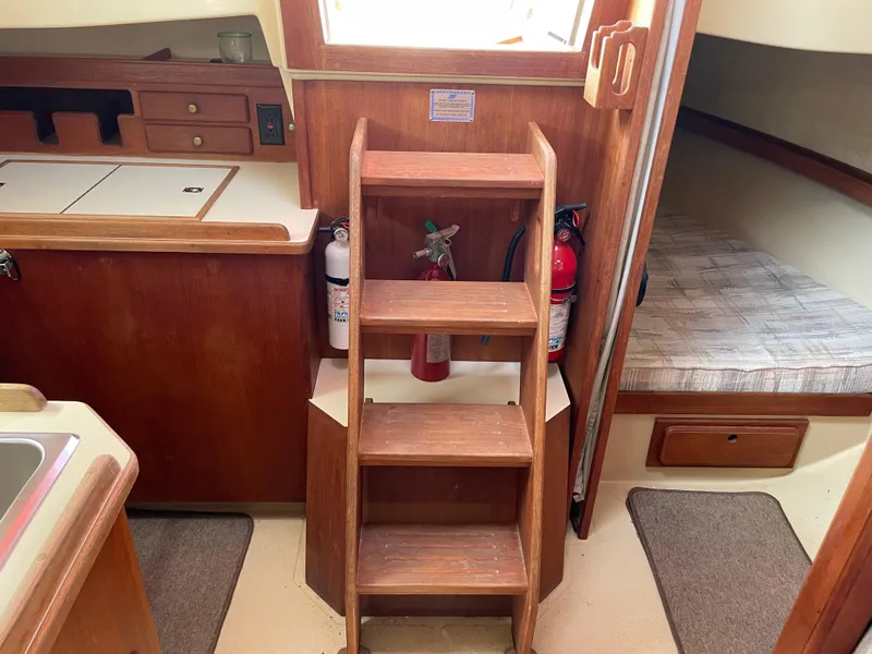Slide: The Image of Interior of 1992 Island Packet 32 sailboat with wooden steps and cozy cabin space. - 22