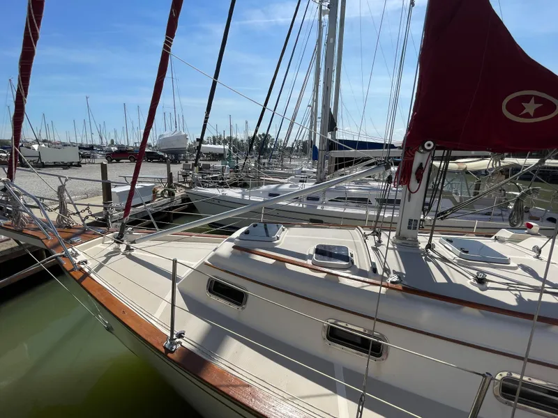 Slide: The Image of 1992 Island Packet 32 sailboat docked at marina under clear blue sky. - 4