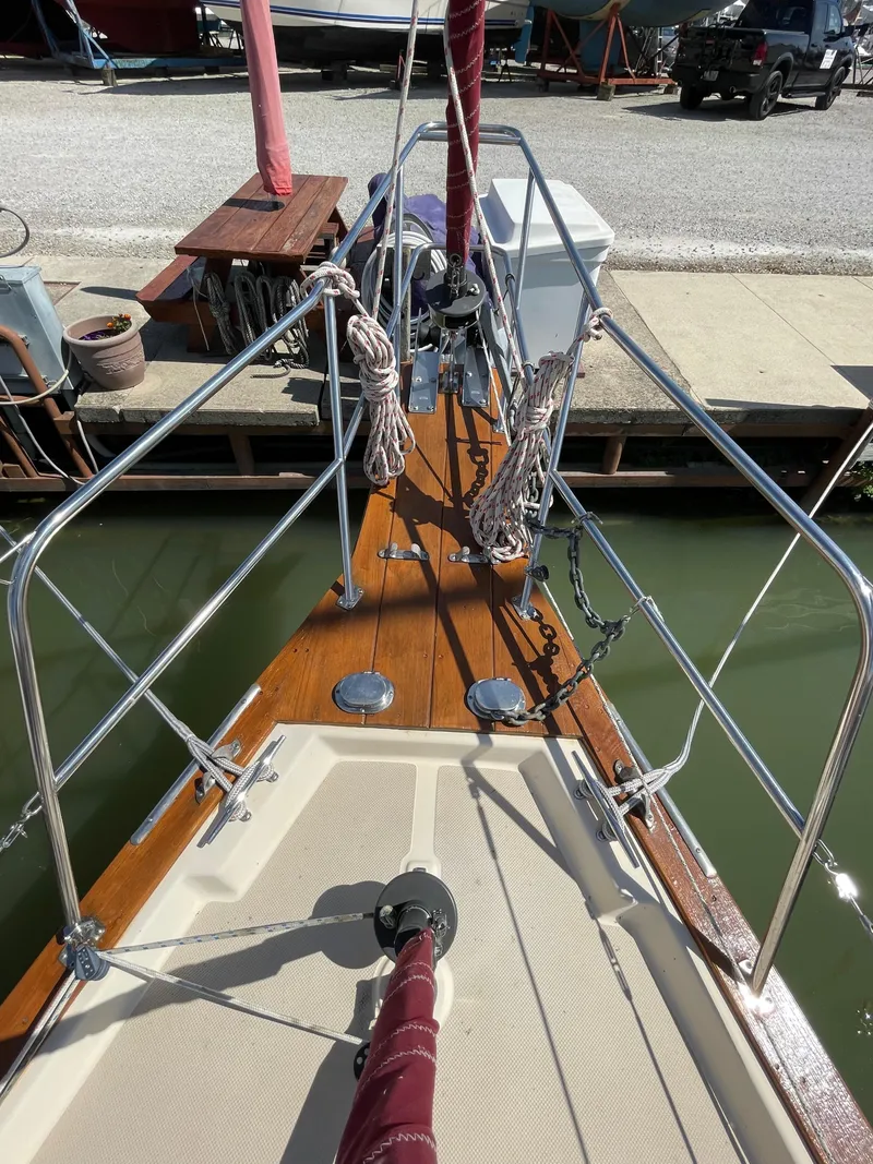 Slide: The Image of 1992 Island Packet 32 sailboat bow with ropes and anchor at dock. - 8