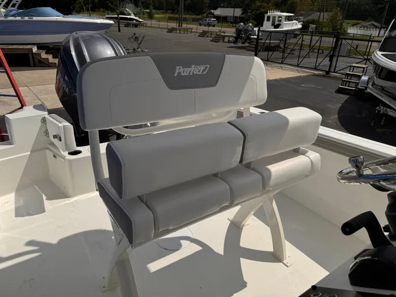 Slide: The Image of 2025 Parker 2200 Center Console boat interior with cushioned seating and steering console. - 12