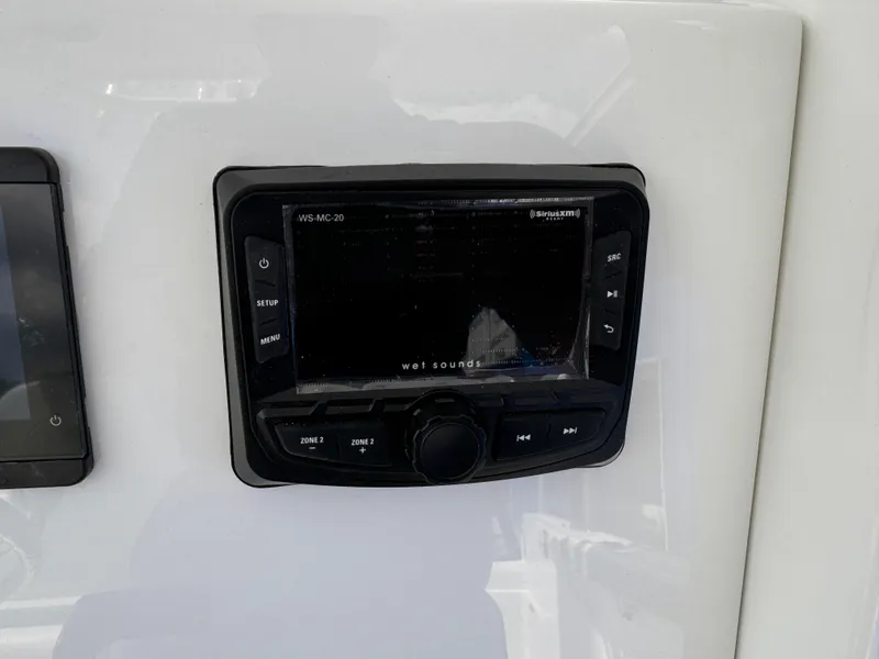 Slide: The Image of 2025 Parker 2200 Center Console boat dashboard with Wet Sounds audio system. - 15