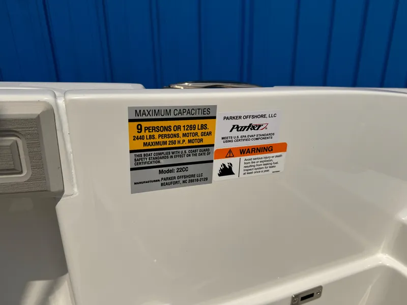 Slide: The Image of 2025 Parker 2200 Center Console capacity label, blue background, safety warnings visible. - 19