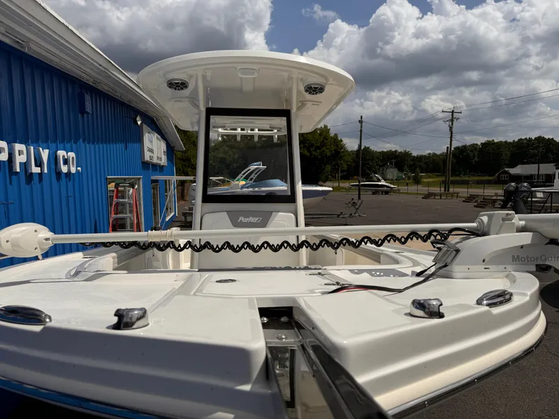 Slide: The Image of 2025 Parker 2200 Center Console boat at a supply store, under a cloudy sky. - 22