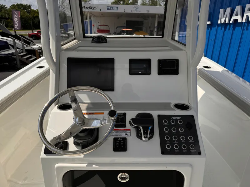 Slide: The Image of 2025 Parker 2200 Center Console boat dashboard with steering wheel and control panel. - 7