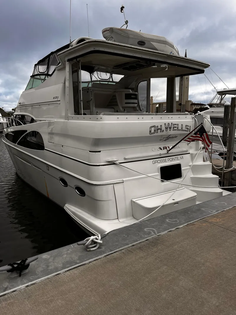 Slide: The Image of 2005 Carver 466 Motor Yacht docked, rear view with American flag, Grosse Pointe, MI. - 0