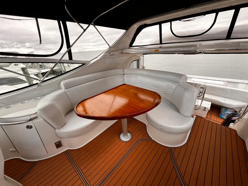 Slide: The Image of Luxurious 2005 Carver 466 Motor Yacht interior with elegant seating and wooden table. - 1