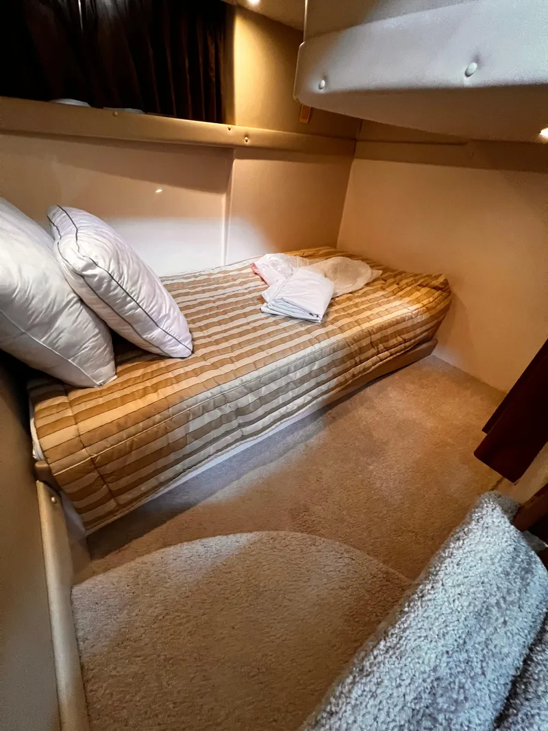 Slide: The Image of Cozy cabin interior of 2005 Carver 466 Motor Yacht with single bed and pillows. - 15