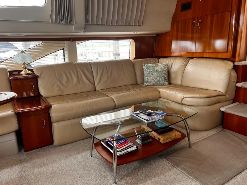 Slide: The Image of Luxurious interior of 2005 Carver 466 Motor Yacht with leather seating and glass table. - 7