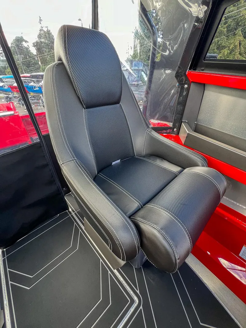 Slide: The Image of 2025 Stabicraft 1850 Fisher interior seat, black leather with red accents. - 13