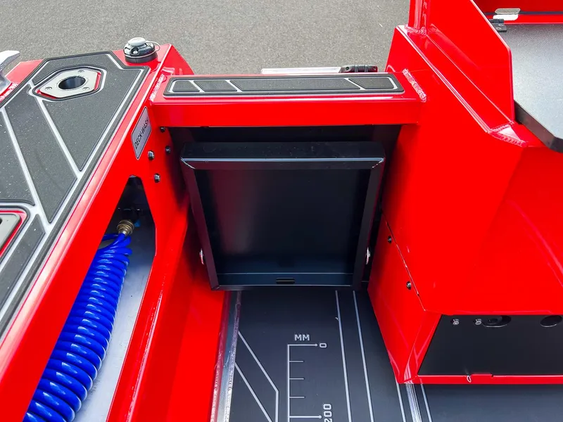 Slide: The Image of Red 2025 Stabicraft 1850 Fisher boat interior with storage compartment and coiled hose. - 19